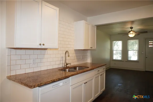 a kitchen with a sink and cabinets