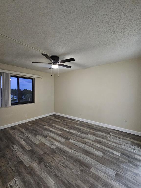 3720 North Pine Island Road, Unit 428 Sunrise, FL 33351 - Photo 11 of 22 a view of an empty room with window and wooden floor