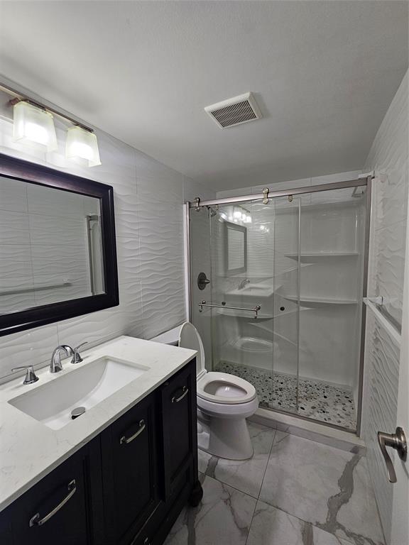 3720 North Pine Island Road, Unit 428 Sunrise, FL 33351 - Photo 13 of 22 a bathroom with a sink toilet a mirror and shower