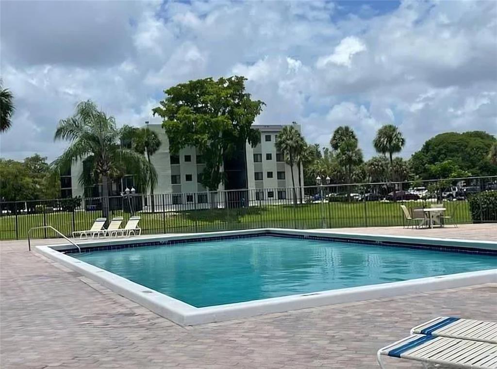 3720 North Pine Island Road, Unit 428 Sunrise, FL 33351 - Photo 21 of 22 a view of swimming pool is middle in the garden