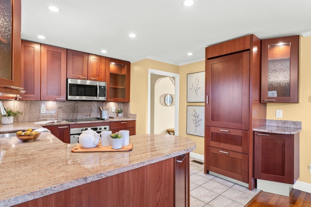 512 Appleton Street Arlington, MA 02476 - Photo 13 of 42 a kitchen with stainless steel appliances granite countertop wooden cabinets a stove top oven a sink and dishwasher