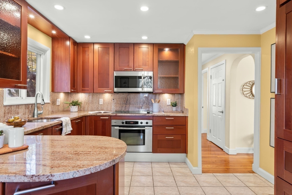 512 Appleton Street Arlington, MA 02476 - Photo 14 of 42 a kitchen with stainless steel appliances granite countertop wooden cabinets a stove a sink and a granite counter tops