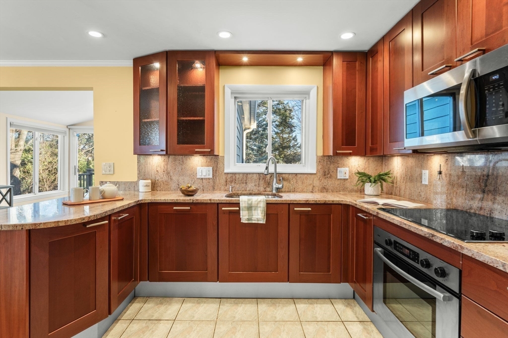 512 Appleton Street Arlington, MA 02476 - Photo 15 of 42 a kitchen with a sink a stove cabinets and outdoor space