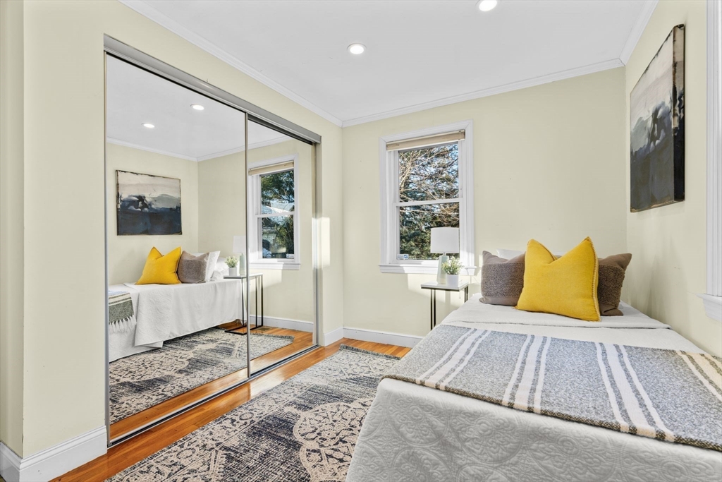 512 Appleton Street Arlington, MA 02476 - Photo 23 of 42 a bedroom with a bed and wooden floor