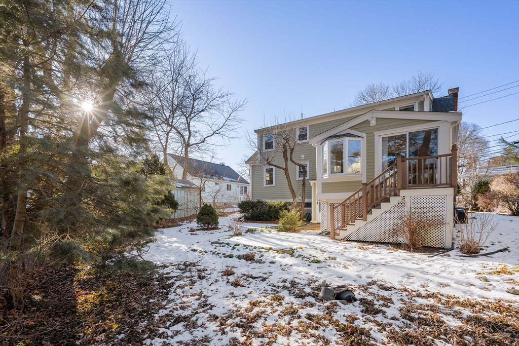 512 Appleton Street Arlington, MA 02476 - Photo 36 of 42 a front view of a house with a yard covered in snow