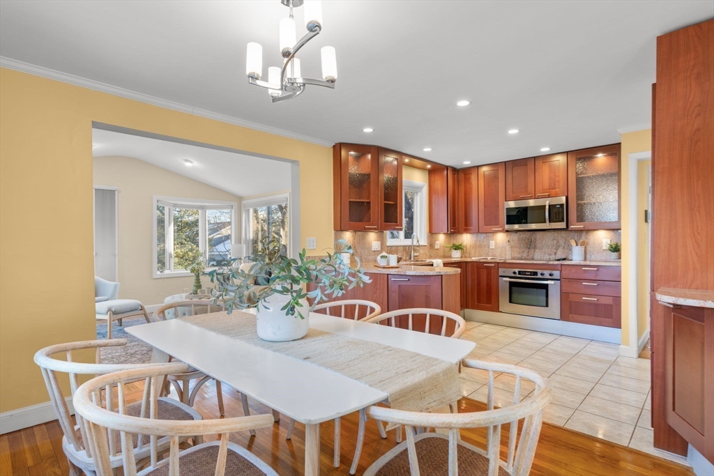 512 Appleton Street Arlington, MA 02476 - Photo 10 of 42 a view of a dining room with furniture a kitchen and chandelier