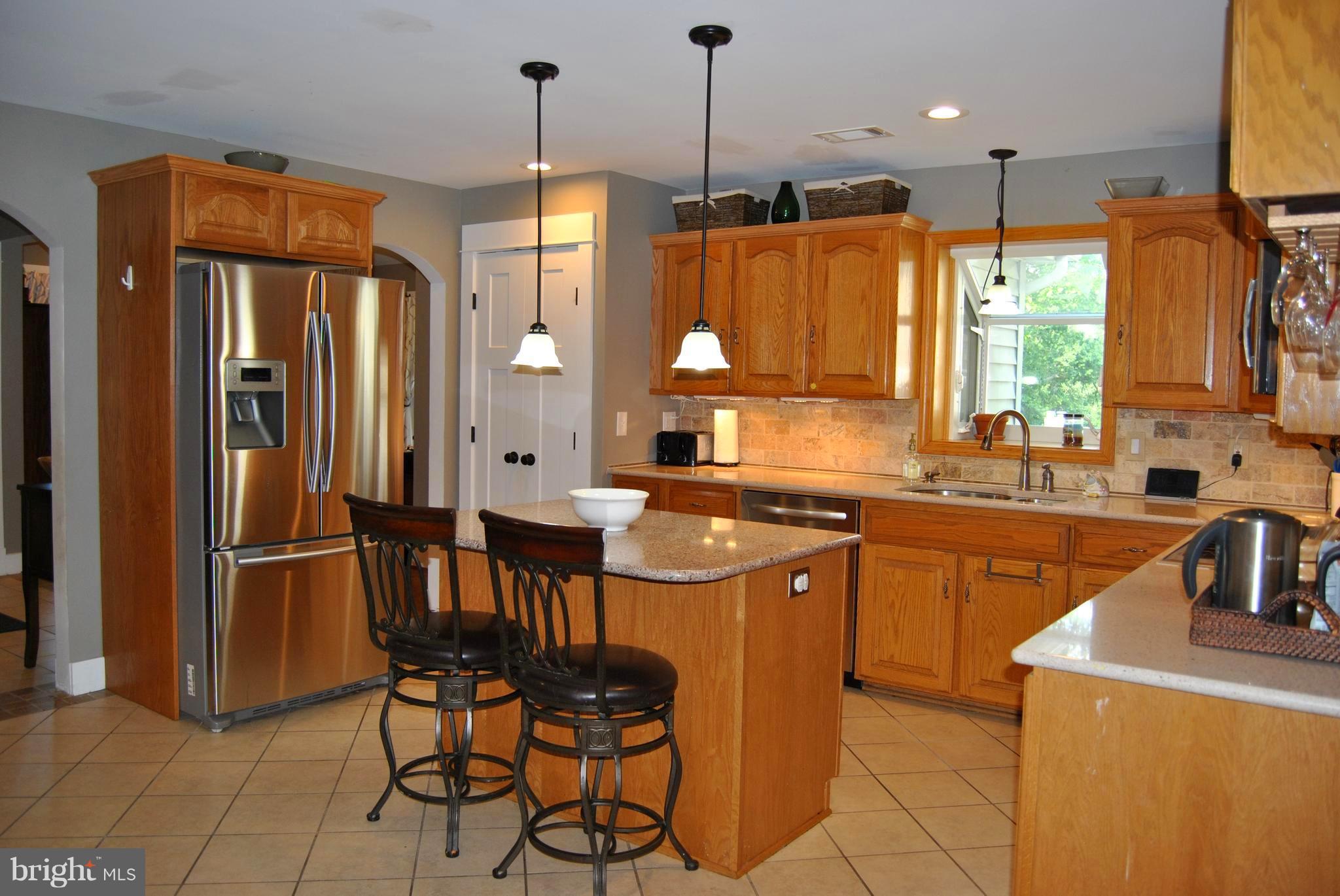 5453 Stone Road Frederick, MD 21703 - Photo 8 of 12 Tons of cabinets/counter space plus island seating