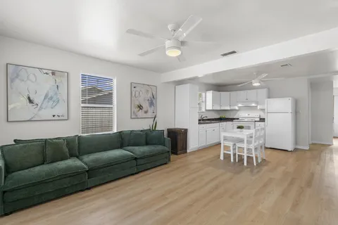 a living room with furniture and kitchen view