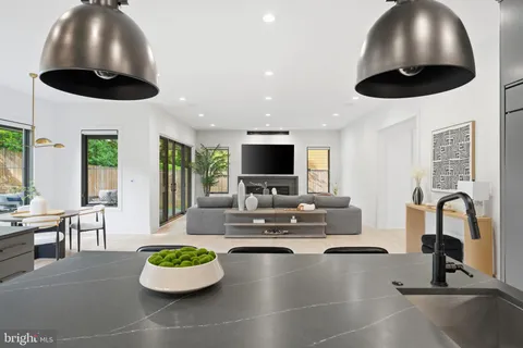 a kitchen with granite countertop a refrigerator and a sink