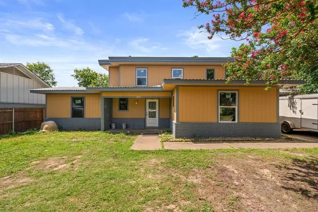 a backyard of a house with yard and barbeque oven