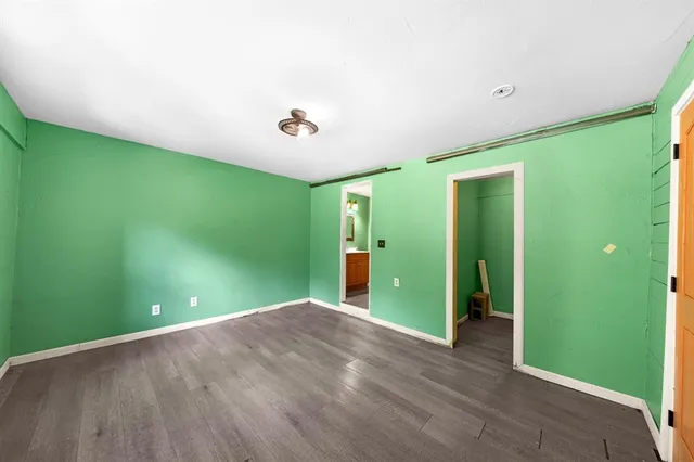 an empty room with a window and a ceiling fan