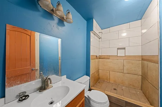 an empty room with a window and a ceiling fan