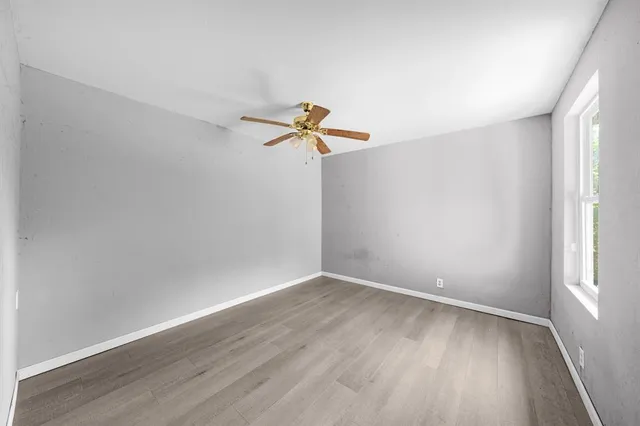 a view of a room with wooden floor and window