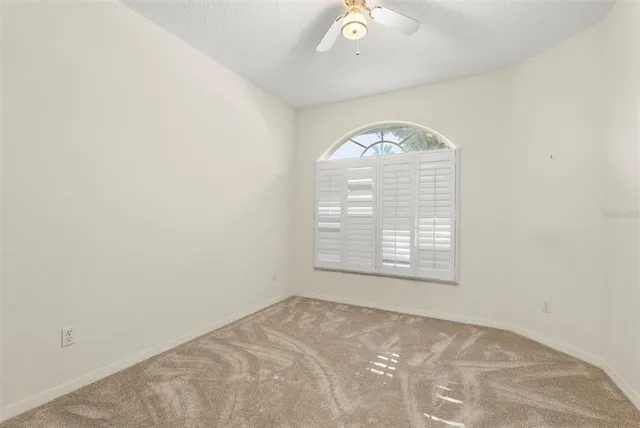 an empty room with a empty space and windows