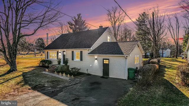 a view of a house with a yard covered in snow