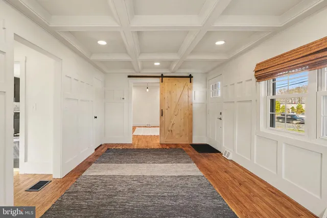 a view of an entryway with wooden floor