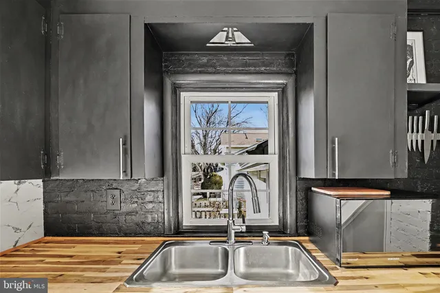 a view of a room with wooden floor and a ceiling fan