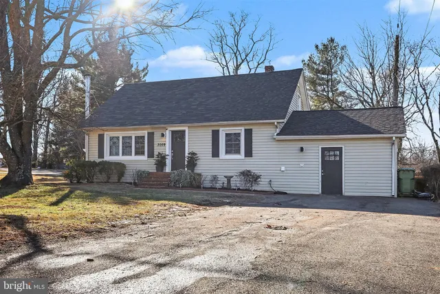 a front view of a house with a yard covered in snow
