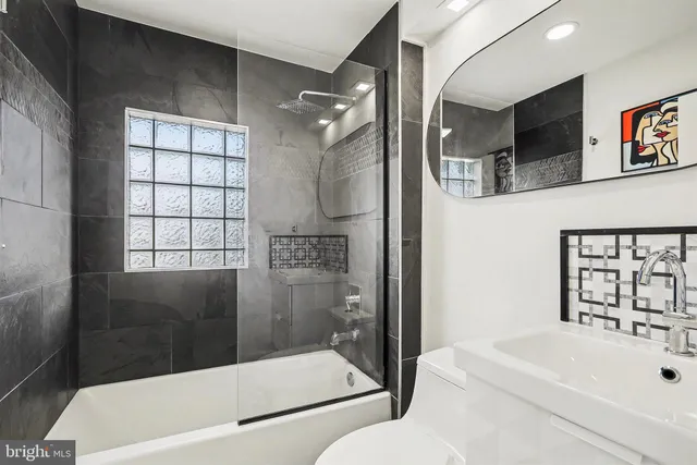 a front view of a house with a yard covered in snow