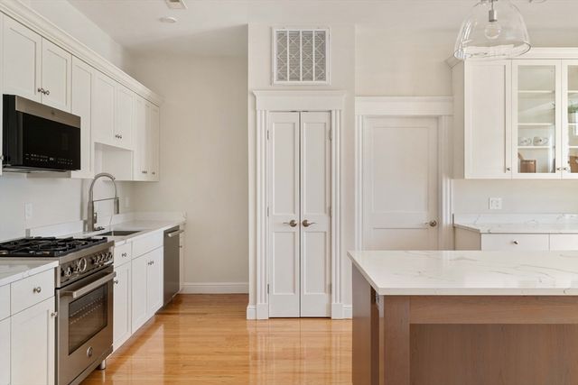 a kitchen with a sink stove and microwave
