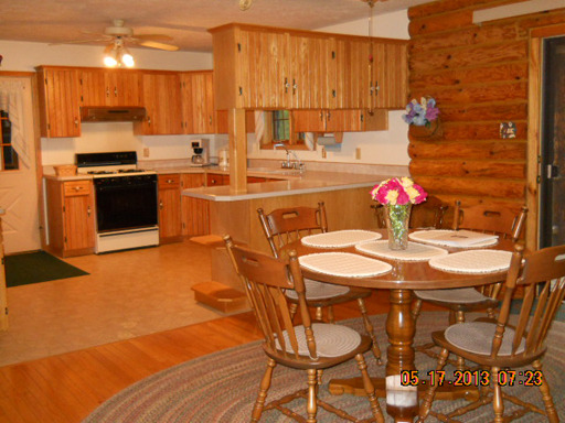 1136 Cumberland Road Magnolia, IL 61336 - Photo 4 of 16 a kitchen with a sink dining table and chairs