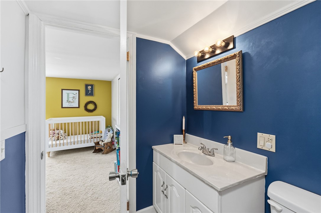 108 Tarrant Street Central, SC 29630 - Photo 25 of 42 A well-appointed bathroom vanity with a crisp white sink offers convenient access to an adjacent bedroom.