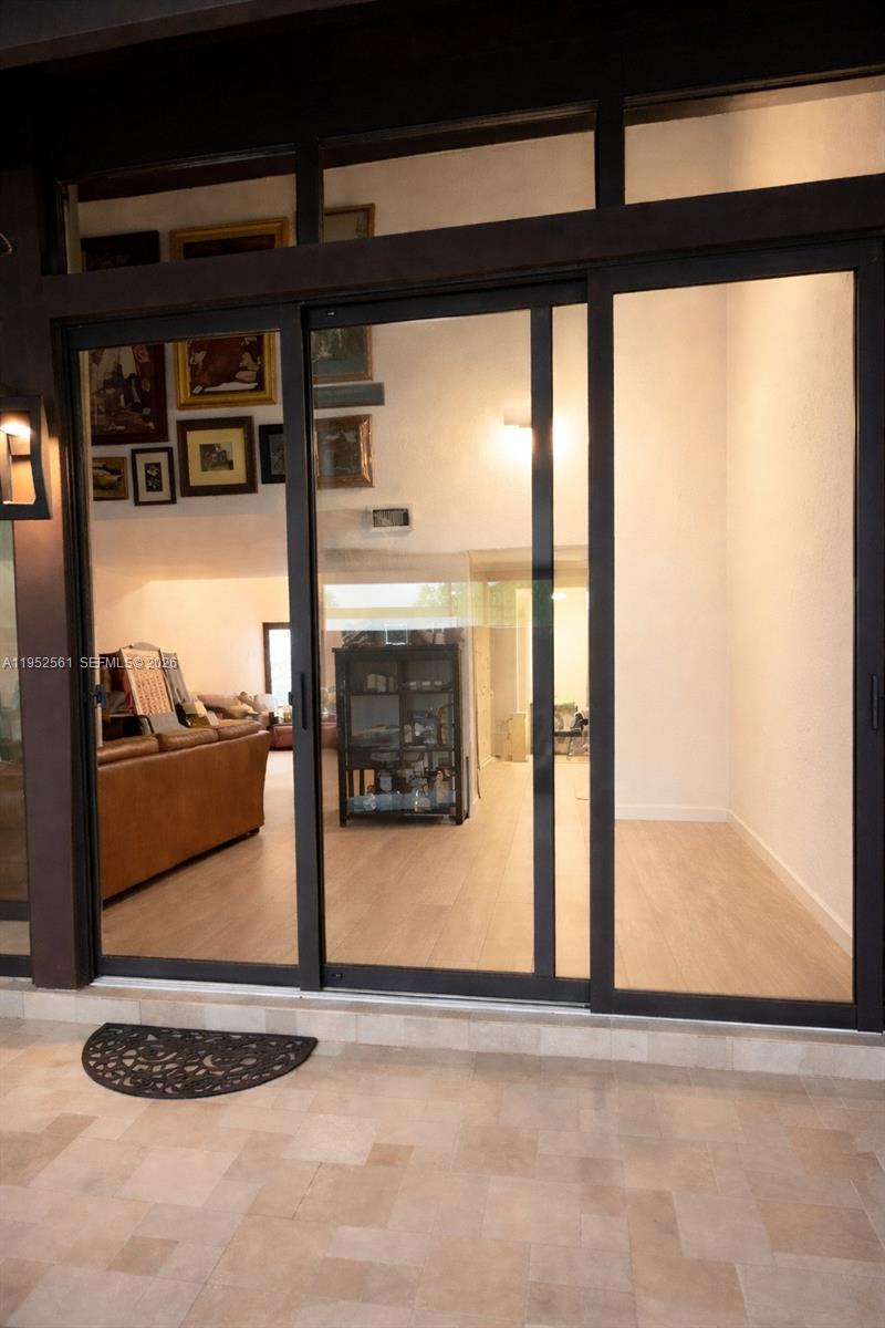1703 Southwest 131st Pl Circle South Miami, FL 33175 - Photo 15 of 36 a view of a living room and a floor to ceiling window