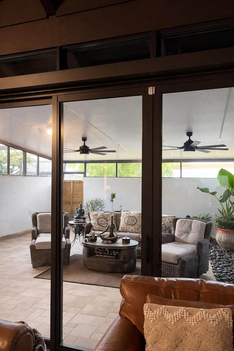 1703 Southwest 131st Pl Circle South Miami, FL 33175 - Photo 16 of 36 a living room with furniture and a floor to ceiling window