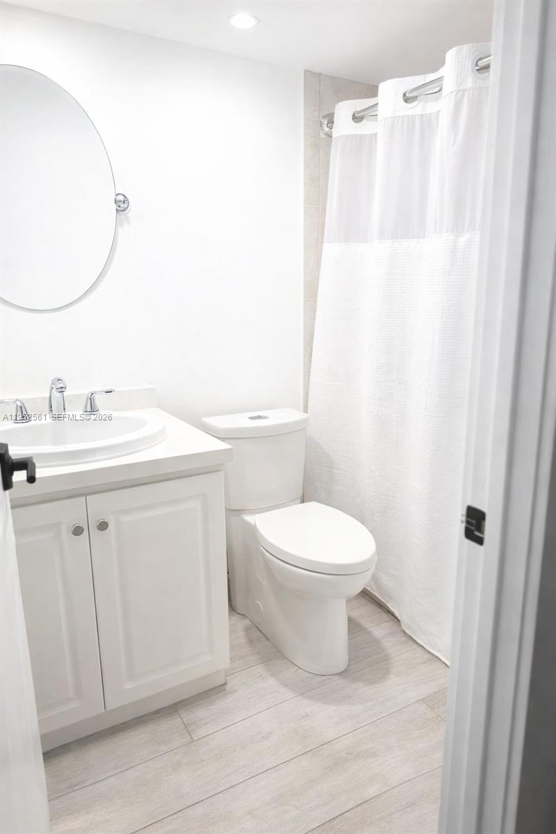1703 Southwest 131st Pl Circle South Miami, FL 33175 - Photo 19 of 36 a bathroom with a toilet a sink and a mirror