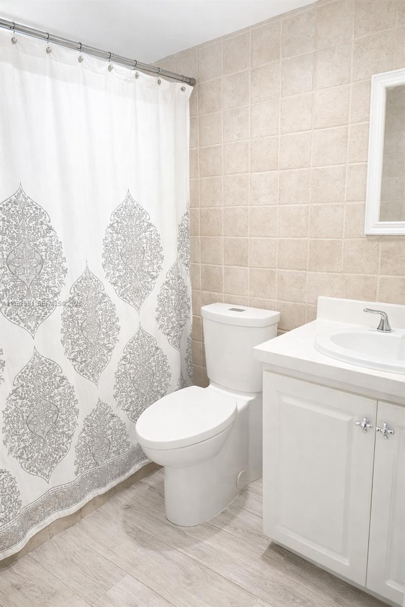 1703 Southwest 131st Pl Circle South Miami, FL 33175 - Photo 20 of 36 a white toilet sitting next to a bathroom sink