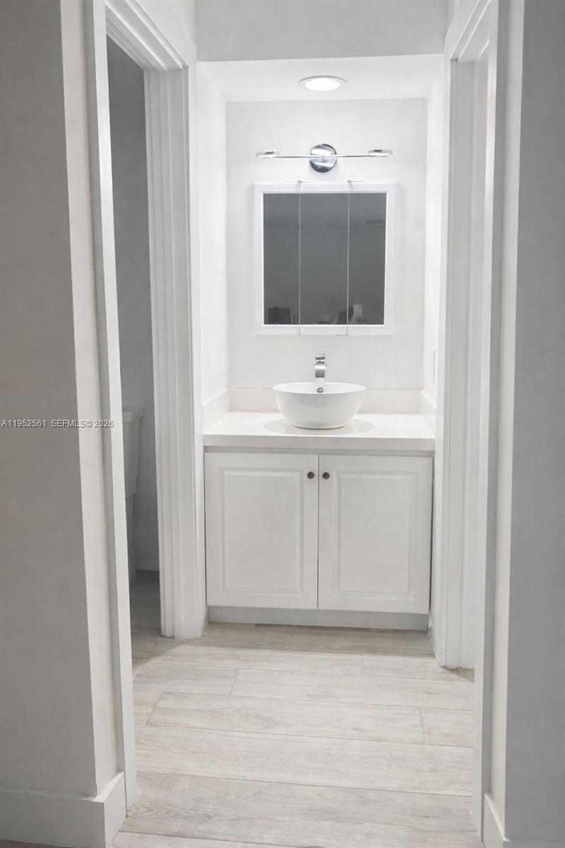 1703 Southwest 131st Pl Circle South Miami, FL 33175 - Photo 27 of 36 a bathroom with a sink and a mirror