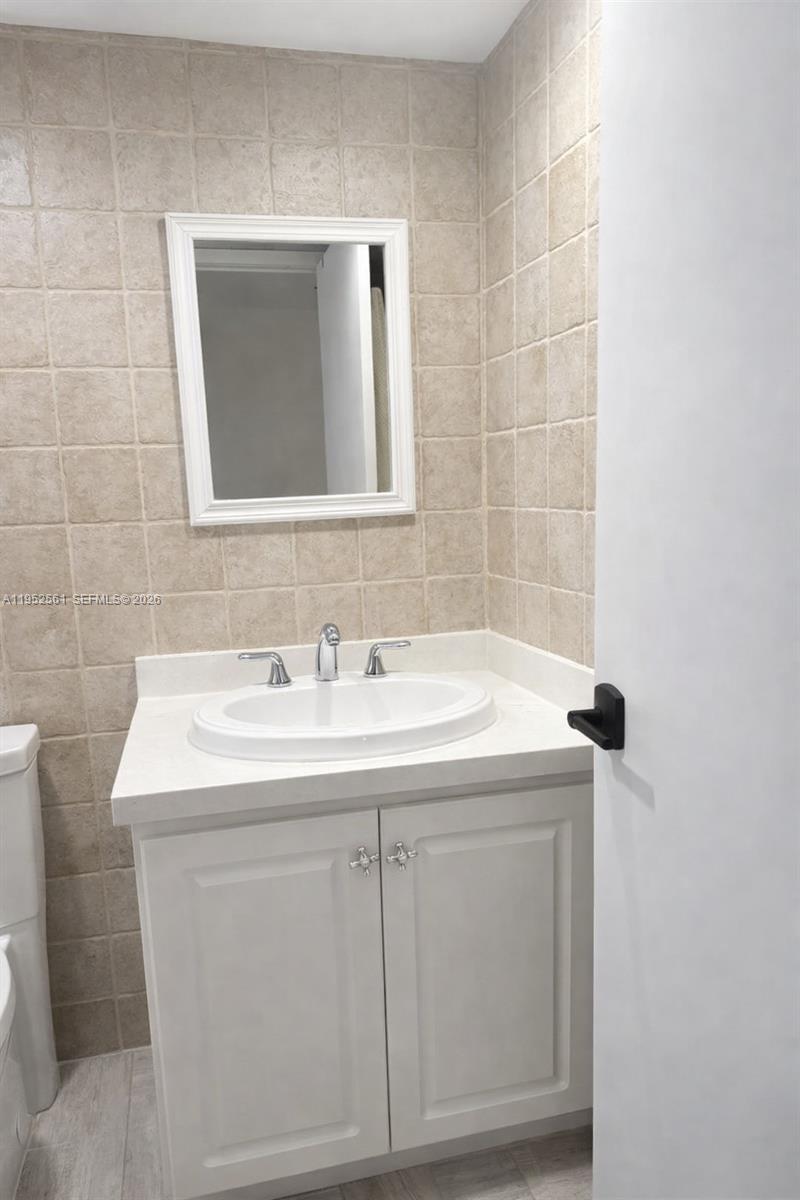 1703 Southwest 131st Pl Circle South Miami, FL 33175 - Photo 32 of 36 a bathroom with a sink and a mirror