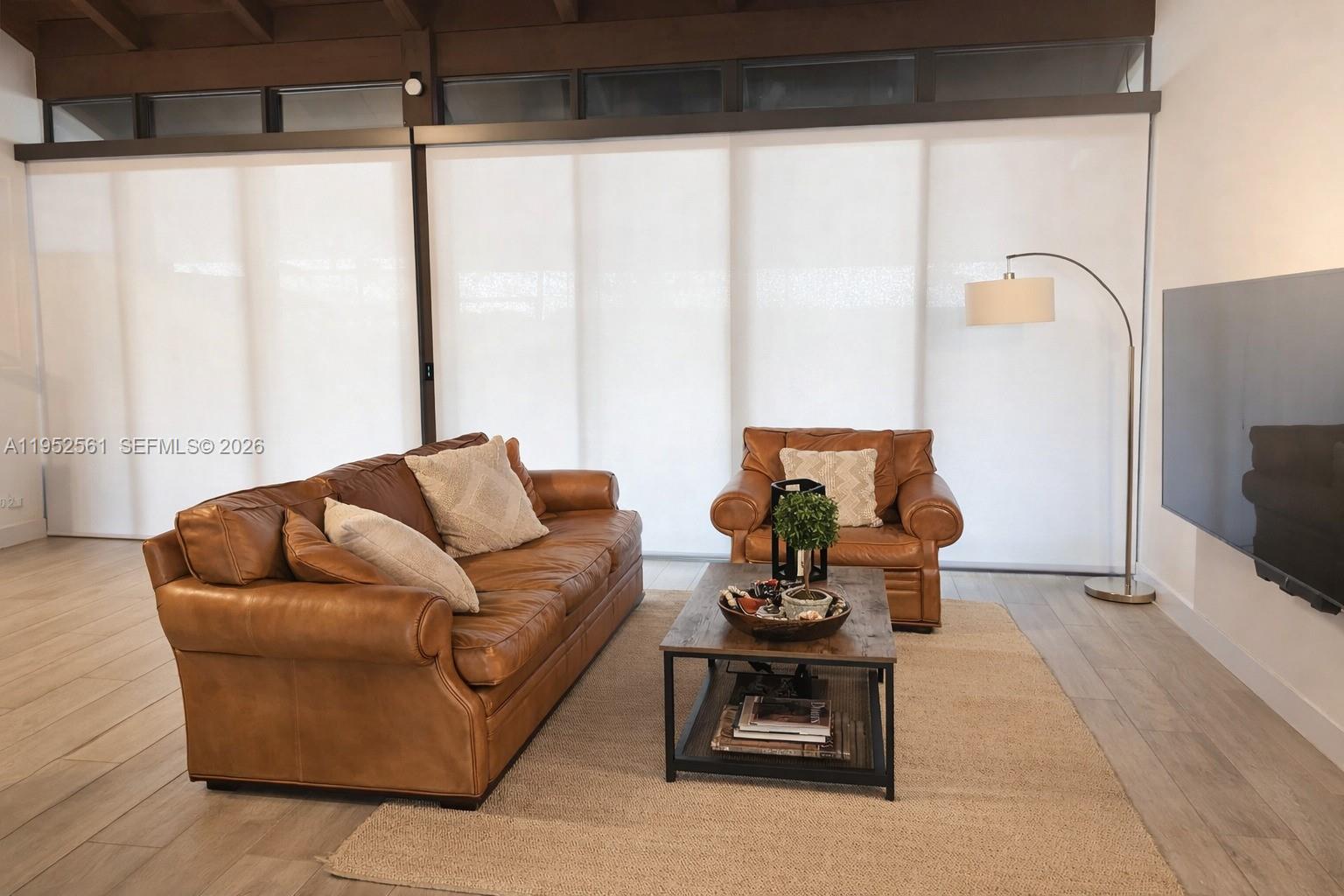 1703 Southwest 131st Pl Circle South Miami, FL 33175 - Photo 7 of 36 a living room with furniture and a flat screen tv