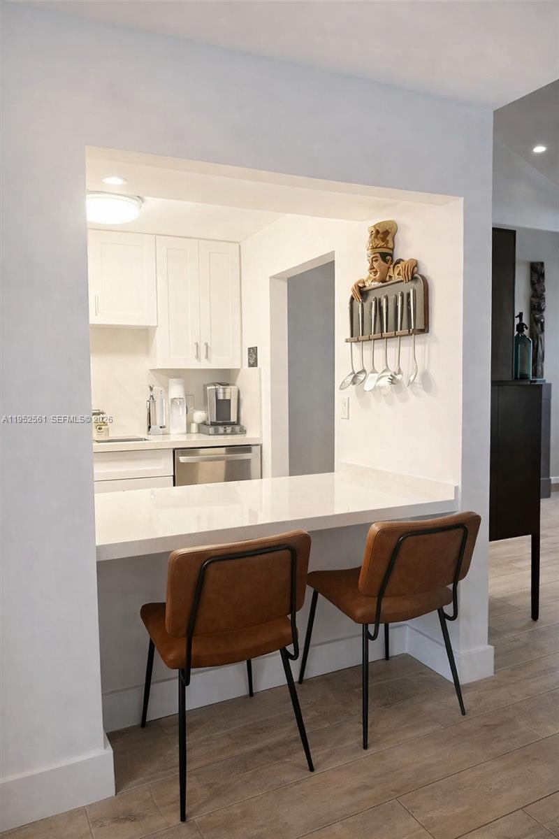 1703 Southwest 131st Pl Circle South Miami, FL 33175 - Photo 9 of 36 a room with a table chairs and a refrigerator