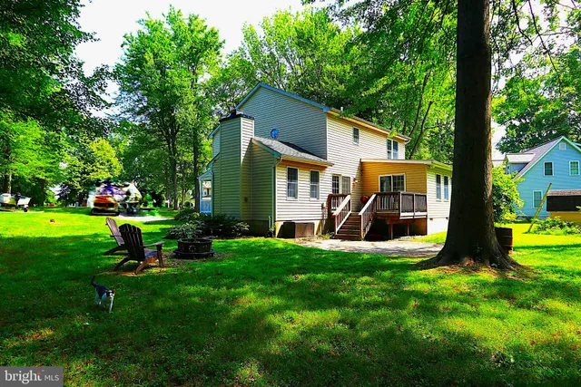 a view of a house with a yard porch and sitting area