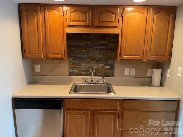a kitchen with a sink stove and cabinets