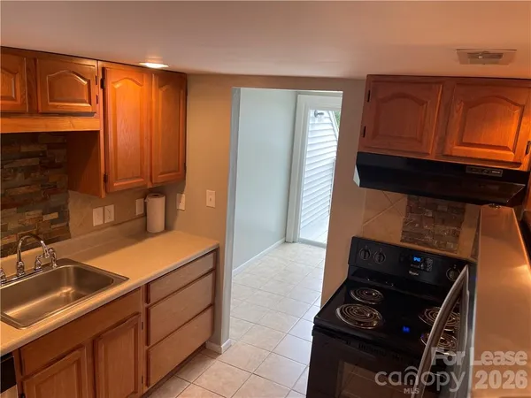 a kitchen with a refrigerator and a stove