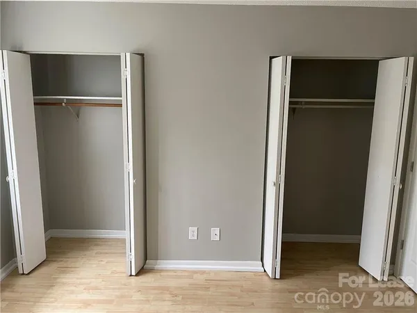 an empty room with wooden floor and a window