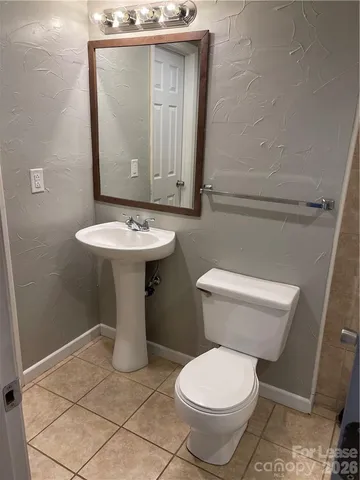 a white toilet sitting next to a bathroom sink