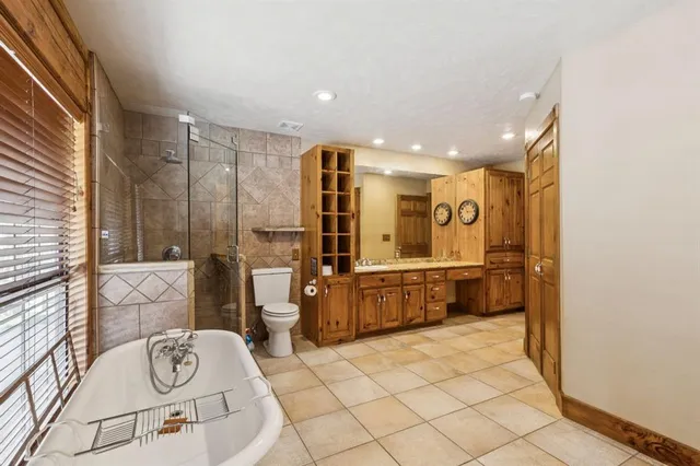 a bathroom with a tub a sink and a mirror