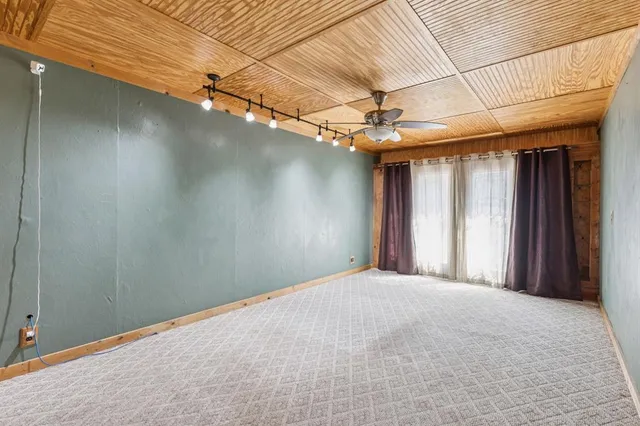 a view of a livingroom with a ceiling fan and window