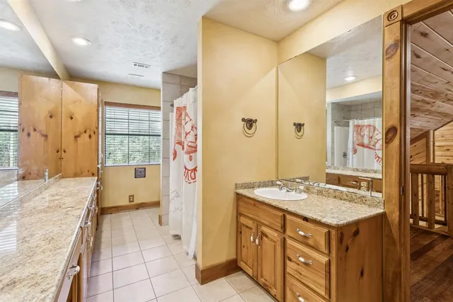 a bathroom with a sink a vanity and a bathtub