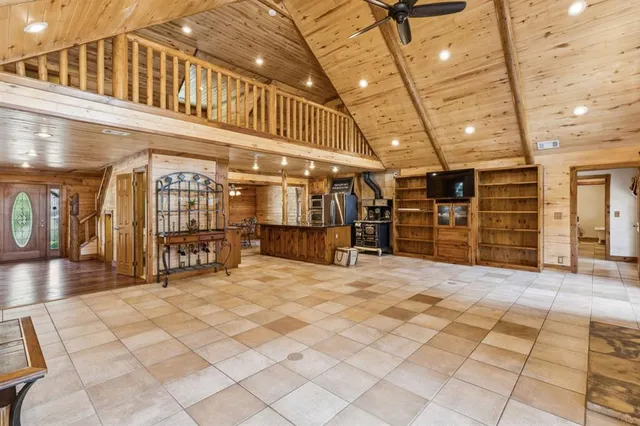 a view of a hall with wooden chairs
