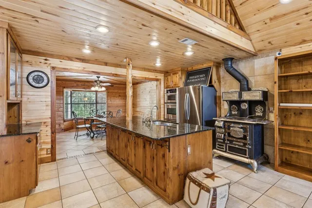 a kitchen with stainless steel appliances granite countertop a stove and a refrigerator