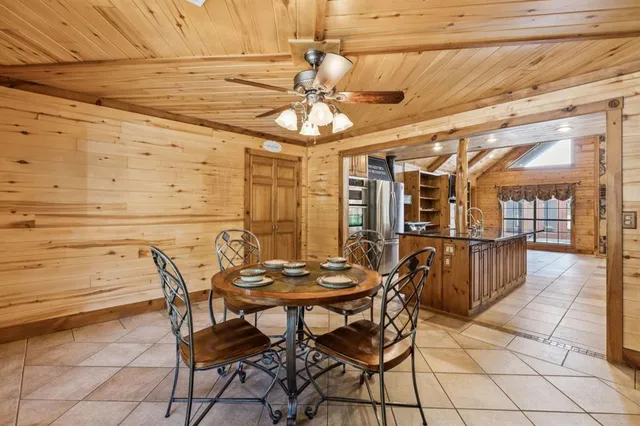 a view of a dining room with furniture and chandelier