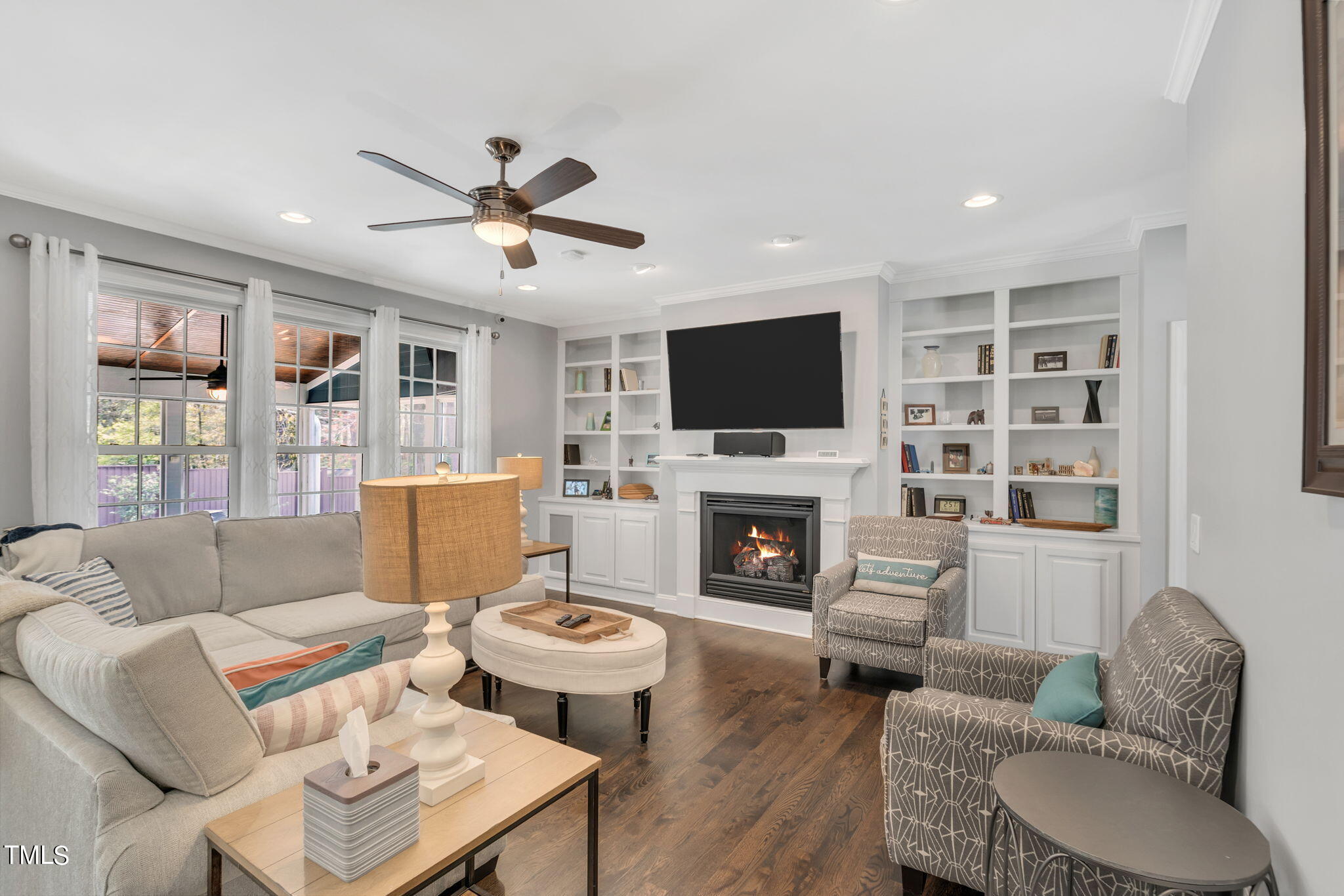 4301 Sprague Road Raleigh, NC 27613 - Photo 12 of 46 a living room with furniture a fireplace and a flat screen tv