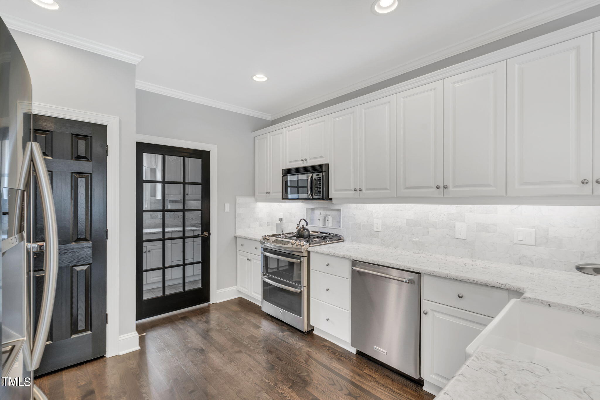 4301 Sprague Road Raleigh, NC 27613 - Photo 16 of 46 a kitchen with stainless steel appliances granite countertop a stove and a refrigerator