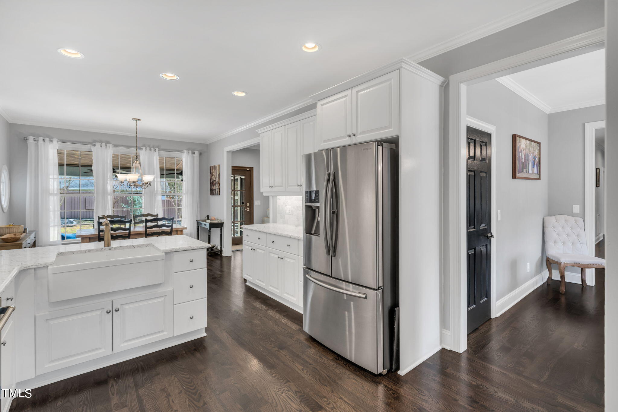 4301 Sprague Road Raleigh, NC 27613 - Photo 17 of 46 a kitchen with white cabinets and stainless steel appliances