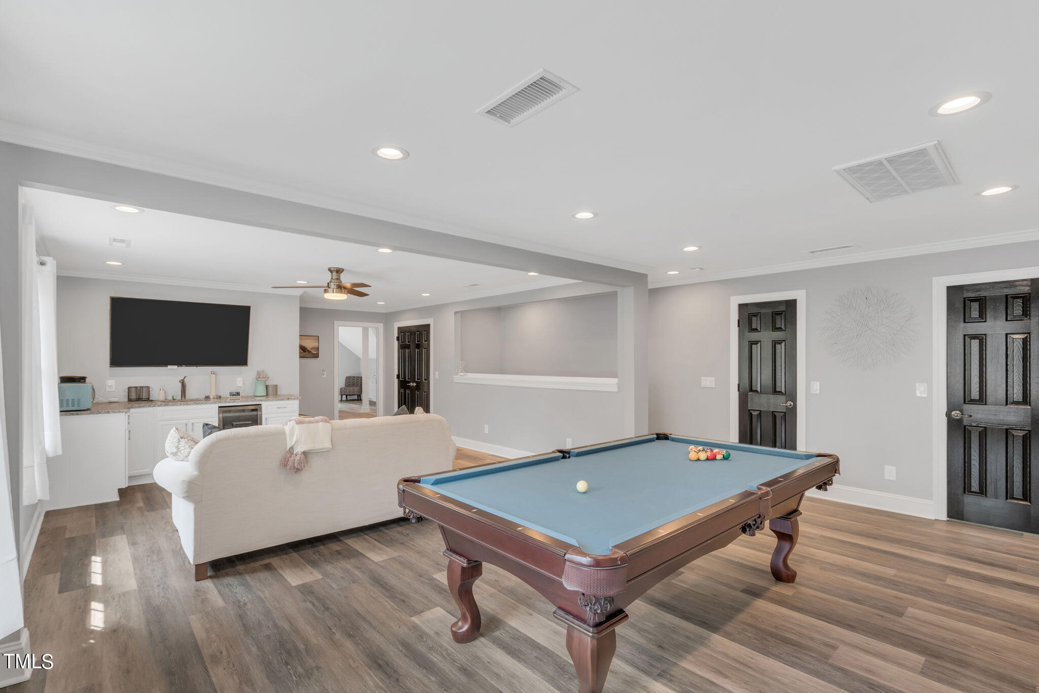 4301 Sprague Road Raleigh, NC 27613 - Photo 27 of 46 a living room with furniture a wooden floor and a flat screen tv