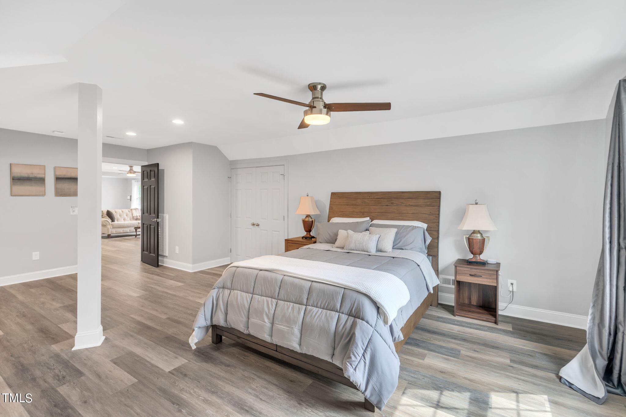 4301 Sprague Road Raleigh, NC 27613 - Photo 31 of 46 a bedroom with a bed and wooden floor